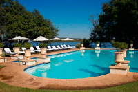 Royal Livingstone Hotel swimming pool. At The Royal Livingstone Hotel, you can expect nothing less than the best service. The aim is to exceed your expectations, allowing you to rediscover romance and luxury during your vacation. You could enjoy the rays of the African sun around the focal point of the hotel's scenery - the sparkling and inviting Victoria-themed swimming pool. At the end of the day, you could wander down to the sundeck to gaze at the sunset and sip at sundowners. The Royal Spa is positioned quite uniquely, on the banks of the Zambezi River. Open gazeboes with stunning views of the river only add to the ambience. The Royal Livingstone Hotel is a Sun International Hotel, meaning you can expect nothing less than the highest level of service and enjoy a myriad of superior activities. 