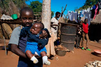 Inhabitants of Mukuna Village. In the Kazungula District of Southern Province lies the rural Mukuni Village. It is just seven kilometres from the world heritage site of Victoria Falls and was founded in the thirteenth century by Bedyango the Leya Tribal Matriach, it was originally called Gundu. However it was renamed in the seventeenth century to Mukuni Village after and in honour of Mukokalya Mukuni N’gombe. Mukuni Village is sitauted on a dry, sandy knoll and has a population in excess of 7000, it is the main village of the Mukuni Chiefdom. The soil is relatively infertile and they cannot rely on agriculture; therefore they have turned to tourism. Mukuni Village is now a tourist destination, introducing an insight into the Leya people’s cultural inheritance; with a wonderful developing curios market, selling intricate wood carvings, stoneware, jewellery and baskets. There are over 100 villages within the Mukuni Chiefdom, with twelve schools and three health centres at Mukuni, Songwe and Katapazi.  