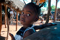 A girl with braids in Mukuni Village. The Mikuni Village is about 30 minutes from Livingstone, home to approximately 1100 Leya people. It's a very peaceful, civil, and clean village founded in the 13th century. We strolled throughout the village, learning about how they live, work, and commune with one another. They build their own tools, crafts, and homes. Their crafts are sold at the end of the village tours where you really have to spice up your bargaining skill! Mukuni Village is an authentic tribal village where thousands of people live and work. In July of each year the Leya people partake in the colorful Lwiindi Ceremony. The local people believe the spirits of their ancestors still dwell in the gorges of the Falls and during the Lwiindi, they offer sacrifices to them for rain.