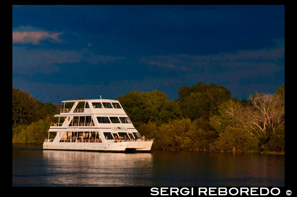 Cruise along the Victoria Falls aboard the " African Queen".  Other boats sailing in the Zambezi River. This is the “Lady Livingstone” boat.  The newly built lady Livingstone famously known as "The Jewel of the Zambezi" has a capacity of 144 pax. Guests are met at their respective hotels/Lodges and transferred to the David Livingstone safari Lodge and Spa. The cruise takes place along the river boundary of the Mosi-Oa-Tunya National Park, total cruise time is approximately 2 hours. During the cruise, clients are likely to see hippos, crocodile and some good birdlife. Possible other game sightings are elephant, giraffe, buffalo and buck. An experienced guide accompanies each cruise and has good knowledge on the wildlife and local history of the area.  Excellent hot and cold snacks are served on board and the bar is well stocked with spirits, good wines, beers and soft drinks. Snacks and drinks are included in the price and served throughout the cruise.  Pick up times are 16h00 in summer (August to April) and 15h30 in winter (May to July).  The Waterfront operates two cruise boats - the "MV Makumbi" and the "MV Mambushi". As well as our regular sunset cruises, the boats are also available for private functions and can be booked on an exclusive basis on request. The cruise is along the river boundary of the Mosi-Oa-Tunya National Park, around Siloka Island and back to the Waterfront jetty. From the boat, sightings of wildlife coming down to the river to drink are common. There are also abundant hippos, crocodiles and birdlife. An experienced guide accompanies each cruise and has good knowledge on the wildlife and local history of the area.