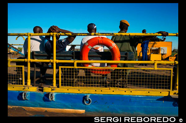 Ferry to cross the Chobe River. From Victoria Falls is possible to visit the nearby Botswana. Specifically Chobe National Park.  Chobe, which is the second largest national park in Botswana, covers 10 566 square kilometres. The park is divided into four main focal points comprising the Chobe River front with floodplain and teak forest, the Savute Marsh in the west about fifty kilometres north of Mababe gate, the Linyanti Swamps in the northwest and the hot dry hinterland in between. The original inhabitants of what is now the park were the San people, otherwise known in Botswana as the Basarwa. They were hunter-gatherers who lived by moving from one area to another in search of water, wild fruits and wild animals. The San were later joined by groups of the Basubiya people and later still, around 1911, by a group of Batawana led by Sekgoma. When the country was divided into various land tenure systems, late last century and early this century, the larger part of the area that is now the national park, was classified as crown land. In 1931 the idea of creating a national park in the area was first mooted, in order to protect the wildlife from extinction and to attract visitors. In 1932, an area of some 24 000 square kilometres in the Chobe district was declared a non-hunting area and the following year, the protected area was increased to 31 600 square kilometres. However, heavy tsetse fly infestations resulted in the whole idea lapsing in 1943. In 1957, the idea of a national park was raised again when an area of about 21 000 square kilometres was proposed as a game reserve and eventually a reduced area was gazetted in 1960 as Chobe Game Reserve. Later, in 1967, the reserve was declared a national park - the first national park in Botswana. There was a large settlement, based on the timber industry, at Serondela, some remains of which can still be seen today. This settlement was gradually moved out and the Chobe National Park was finally empty of human occupation in 1975. In 1980 and again in 1987, the boundaries were altered, increasing the park to the present size.