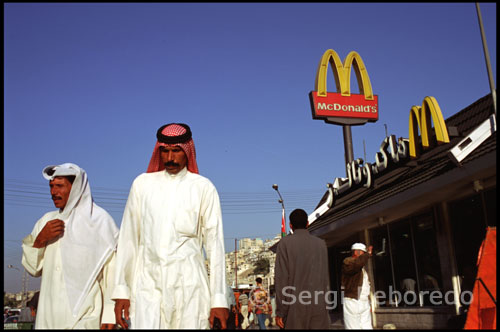 Down the hill from ACOR and to the left a short distance are a shwarma stand, KFC, Popeye's, Pizza Hut, Chili House and a real McDonalds. These are legitimate franchise operations nearly up to US style, but with no pork products. Eating out is not an everyday activity in Jordan. Proper restaurants will be visited only for business affairs or family celebrations. Restaurant meals are later than normal American evening meal times. Fancier restaurants are typically open from 7:30 PM to midnight or 1 AM for dinner, with few people besides tourists appearing earlier than 9:30. A meal will cost JD 10 to JD 15 for two courses and beer or wine. The major hotels all have a variety of restaurants, but the best food is usually in non-hotel establishments. Reservations are rarely necessary, especially if you go early, but all restaurants will now and then be reserved for a party. At the other end of the scale is the shwarma stand, in most cases for carry-out only. Meat (usually a choice of beef or chicken) is wrapped in a small unleavened bread, with some vegetables and yogurt or other sauce. The "sandwich" is smaller than the equivalent gyro, donar kebab, or rolly-polly, but the price is right - JD .200 to JD .400. Stands will normally be open from before noon to fairly late in the evening, and usually sell soft drinks and water. In between are a growing number of informal restaurants, and fast food places. Many are oriental, with staples such as hummus or shwarma, but a growing number are western-style with hamburgers, pizza and chicken. Some are open all afternoon. Following are a selection of the better ones. Prices are inexpensive (JD 5 or less for a meal with a beer, if available) unless noted; medium (JD 10 or so); or high (JD 15 - 20).