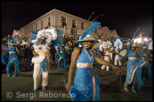 Junkanoo was celebrated in various parts of the Americas, and variants of the word's orthography may be found in each place - Jonkonnu or John Canoe in Jamaica; John Kuner in North Carolina; and John Canoe in Belize. In The Bahamas, newspaper accounts of Junkanoo in Nassau between 1849 and 1950 referred to the parade alternately as the Christmas Masquerade, Christmas Carnival, and John Canoe. By the mid-1950's the terms John Canoe and Junkanoo were used interchangeably, and by 1970 Junkanoo became the parade's standard nomenclature. Junkanoo groups "rush" from midnight until shortly after dawn, to the music of cowbells, in costumes made from cardboard covered in tiny shreds of colourful crepe paper, competing for cash prizes.
