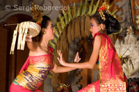 Dance called Legong Dance at Ubud Palace. Several young people on stage dressed in magnificent robes of gold brocade and synchronize their movements slow and strenuous. Ubud, Bali. Indonesia.