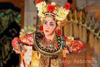 Dance called Legong Dance at Ubud Palace. Several young people on stage dressed in magnificent robes of gold brocade and synchronize their movements slow and strenuous. Ubud, Bali. Balinese woman.