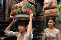 Several women go to Book of the Sacred Monkey Forest to pray and leave offerings at the celebration of Galungan. Galungan festival, the largest in Bali, symbolizes the victory of Drama (virtue) on Adharma (bad). During day-long celebrations Balinese parade through the whole island adorned with long bamboo sticks (Penjor) decorated with ears of corn, coconut, rice cakes and pastries as well as white or yellow cloth, fruits, flowers. This festival is celebrated every 210 days. Ubud. Bali.