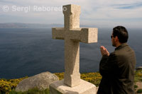 Praying in a cruceiro on the back of the lighthouse Fisterra.