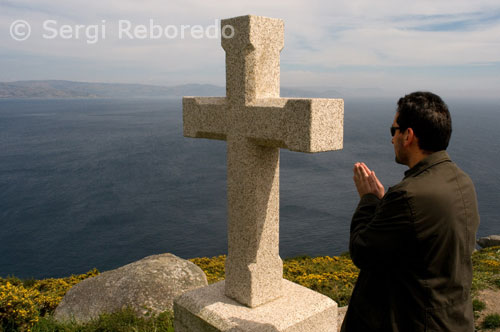 Praying in a cruceiro on the back of the lighthouse Fisterra.