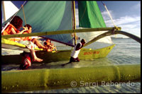 Tourists. Sailing boat for practice. White beach. Boracay. 