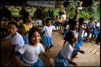 Children will sing and dance at the margins of the Loboc River to the arrival of tourists while they made a boat trip. Loboc. Bohol.