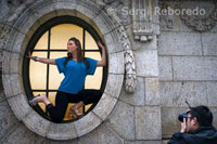 A fashion photographer uses the windows of the New York Library overlooking Bryant Park to photograph a model. 5th Ave and 42nd Tel 212-930-0830. In the back of the park is the public library, which is the largest in the world and the largest U.S. In the reading room there are still original brass lamps.