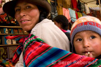 A mother and her son dressed in a traditional costume in Pisac Sunday market day. Pisac. Sacred Valley.