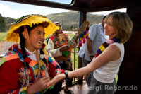 Inside the train. Musicians and dancers with costumes dancing to liven up the journey for passengers in the Andean Explorer train Orient Express which runs between Cuzco and Puno.