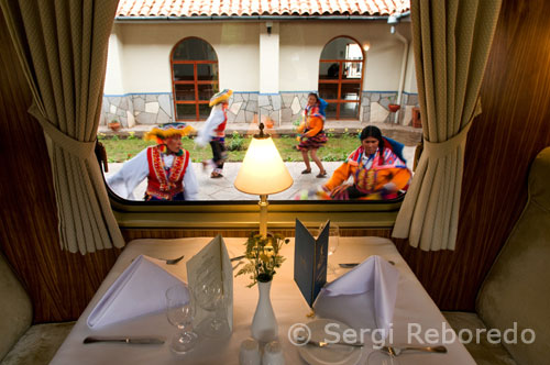 While sipping the welcome drink guests mingle, meeting other passengers while conversing to the sounds of Andean pipes filling the air and folkloric dancers swirling and twirling in a kaleidoscope of reds, blues, yellow, and oranges. On board the blue and gold carriage, an on–line version of the "New York Times" is waiting on the reserved tables replete with white linen and crystal. The train, consisting of two dining cars, an observation bar car, and a kitchen car, reflects the sumptuous luxury of the 1920s Pullman era. 