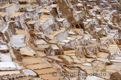 Towards the northwest of the Maras village are the famous " salt works", which are possible to reach walking by the trail or by car through a dusty road that is almost useless in the rainy season. The Maras "salt works" to which some people call "salt mines" are constituted by about 3000 small pools with an average area of 5 m² (53.8 ft²), constructed in a slope of the "Qaqawiñay" mountain. People fill up or "irrigate" the pools during the dry season every 3 days, with salty water emanating from a natural spring located on the top of the complex, so that when water evaporates the salt contained in it will slowly solidify. That process will be carried out approximately during one month until a considerable volume of solid salt is obtained; about 10 cms. (4 inches) high from the floor. That solid salt is beaten thus granulated, then packed in plastic sacks and sent to the region's markets; today that salt began being treated with iodine, thus, its consumption is not harmful.